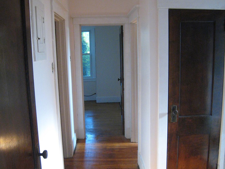Hallway from dining room to bedrooms and bathroom. Linen closet is the door on the right. Bathroom door is on the far right, out of view. Bedroom 2 is straight back through the open door.