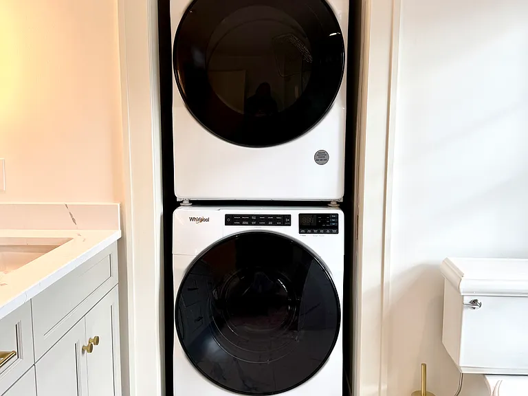 Master bathroom with walk-in shower and front-load washer/dryer