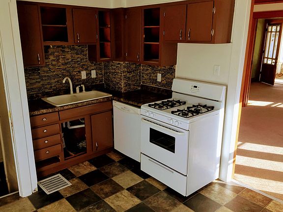 Remodeled kitchen with mosaic backsplash, new floors, dishwa