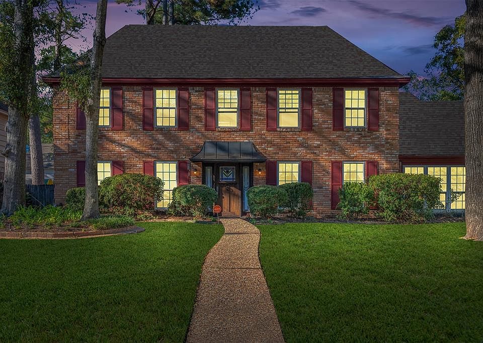 Framed by mature trees and lush landscaping, this 5 BR, 3.5 Bath corner lot nestled in the heart of Greenwood Forest displays a beautiful brick front-elevation and a timeless architectural style. A stunning solid-wood door with in-laid stained glass 
