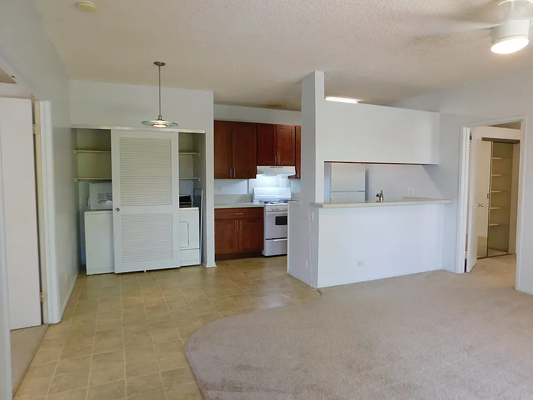 View from front door: kitchen with gas range; new range hood; disposal; full size washer; full size gas dryer; dining area.