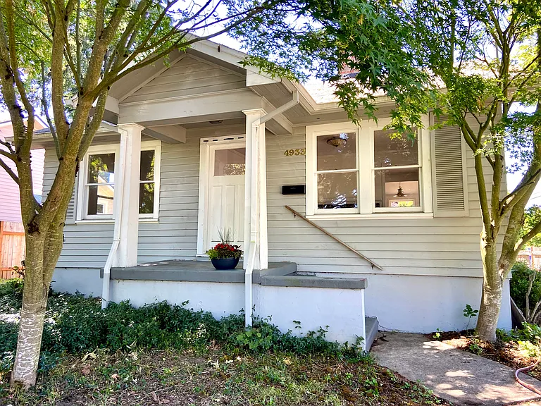 Front of house with adorable porch and trees for shade