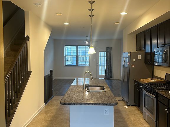 Modern kitchen with drop lights and recessed lights.