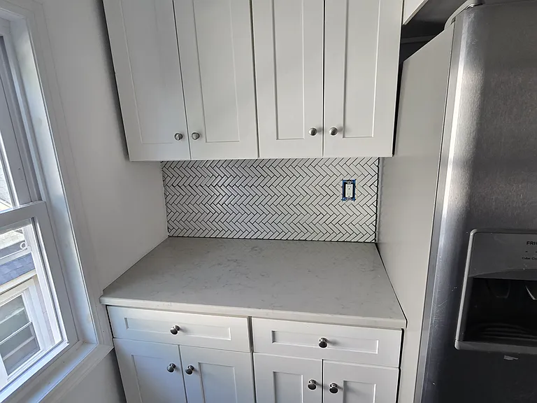 Kitchen area with counter space and cabinets.