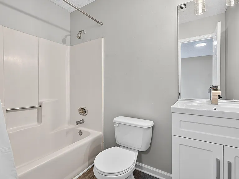 Full bathroom with tub/shower combo, updated vanity with storage, and mirror for everyday convenience.