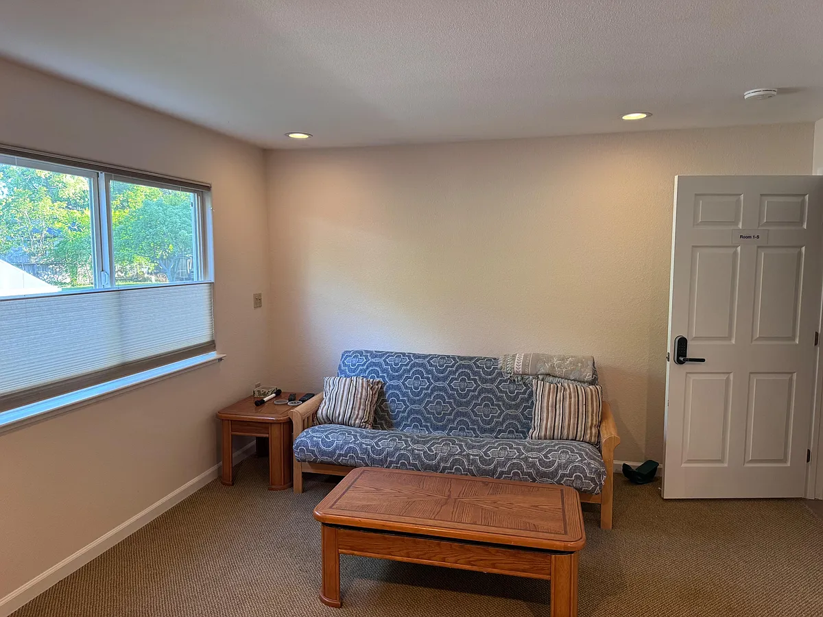 Futon Bed and seating, and coffee tablean easy spot to relax or read between errands. - Whitman Rd