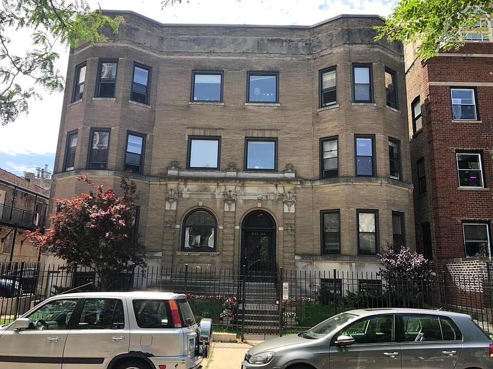 Building exterior with parking lot at left