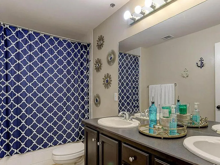 Downstairs Bathroom with Dual Sinks & Soak-In Tub