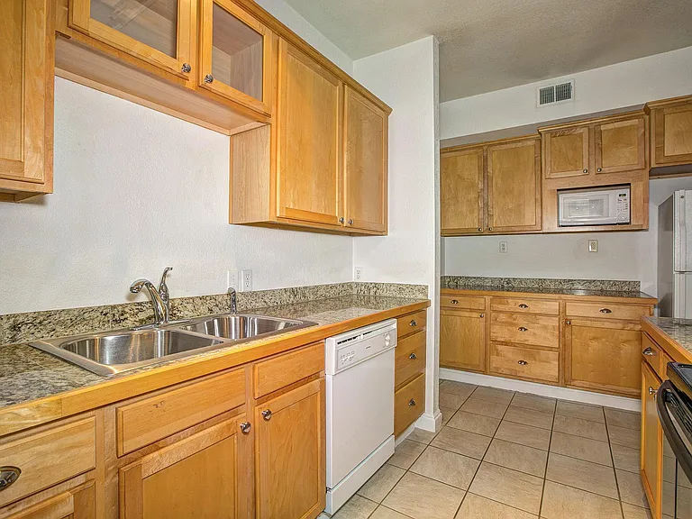 The kitchen is now updated quartz countertops