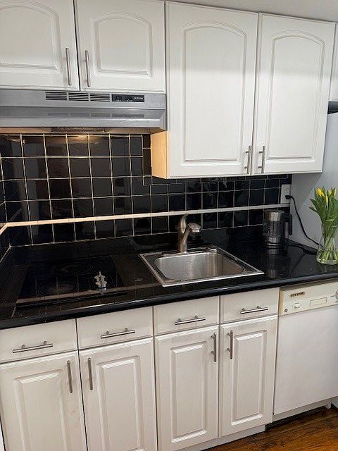 kitchen with granite counter top, dishwasher and brand new refrigerator