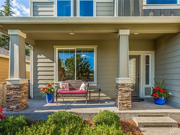 Covered Entry and Front Porch Greets your Guests. Elegant Glass Front Door & Side Lite.