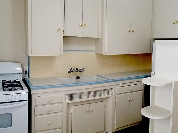 The Right part of the kitchen which has the refrigerator and