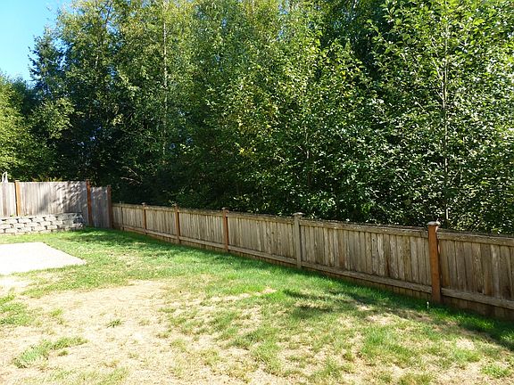 Back yard fenced overlooks greenbelt
