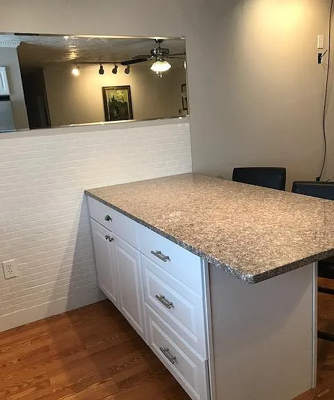 Oversized granite island has seating area