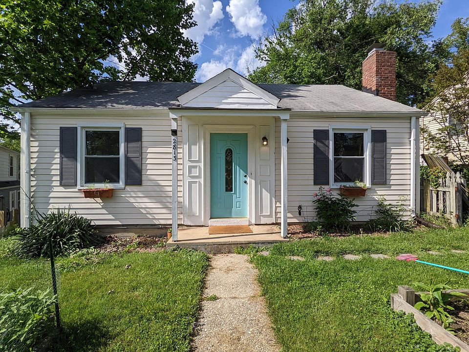 Front yard has multiple flowerbeds with perennials planted and space for a small vegetable garden.
