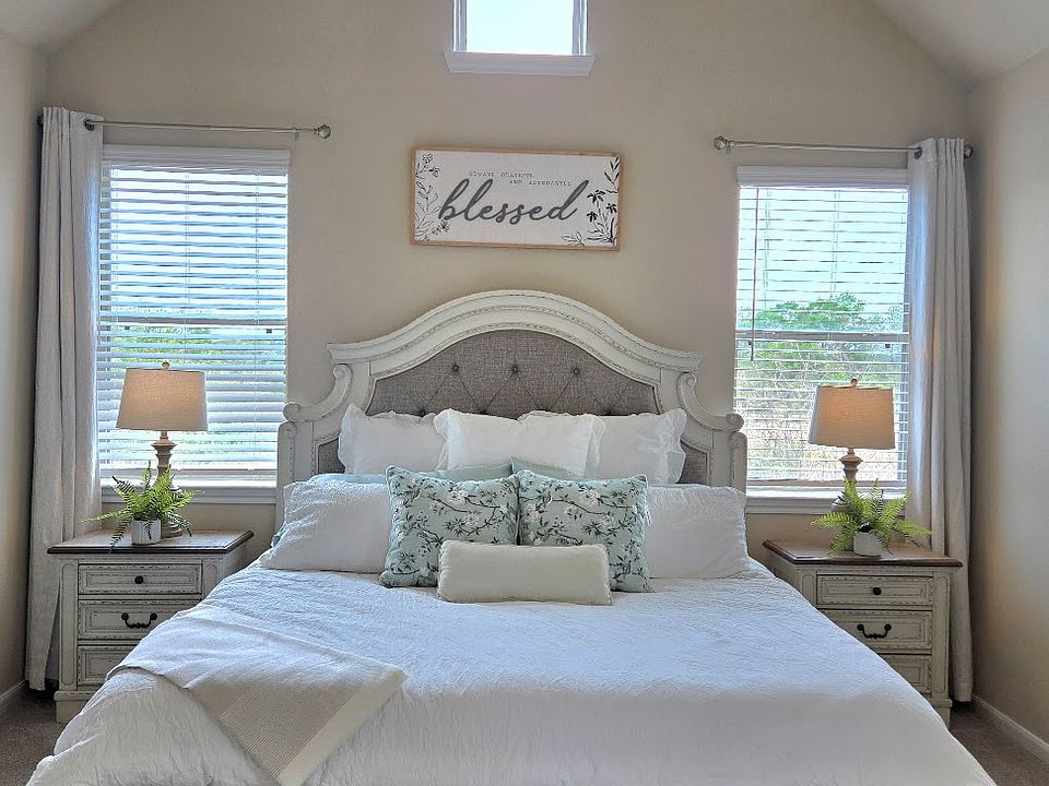 Primary bedroom with king size bed overlooking a tree farm.