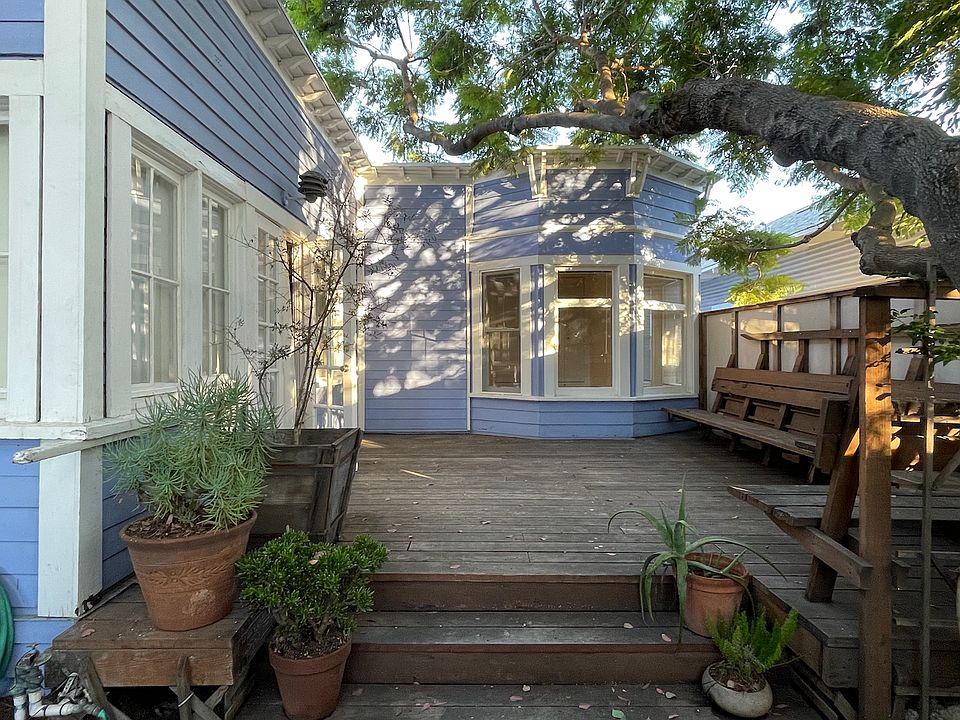 View from the garden to the deck. The bay window is the bedroom, and the living area is to the left.