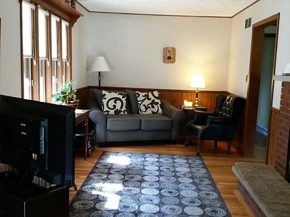 Family room with brick fireplace, wood floors, and a gorgeous view!