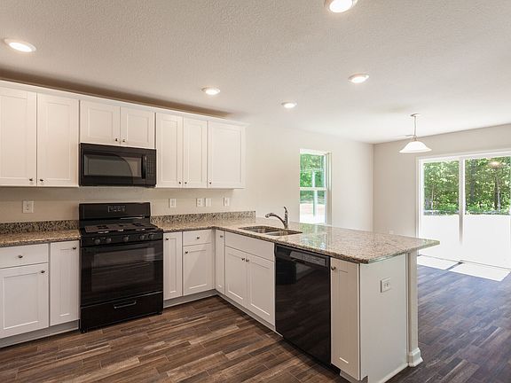 Stunning kitchen has spacious cabinets granite countertops