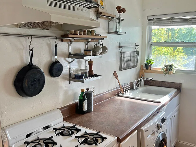 Kitchen with washer/dryer combo. No dishwasher.