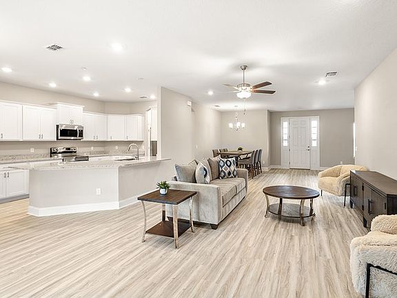 Inside, you ll find a spacious, open living area with luxury vinyl plank flooring.