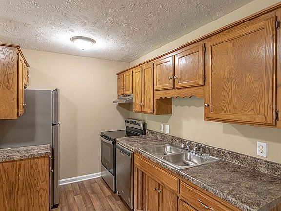 Kitchen with stainless appliances and wooden cabinetry