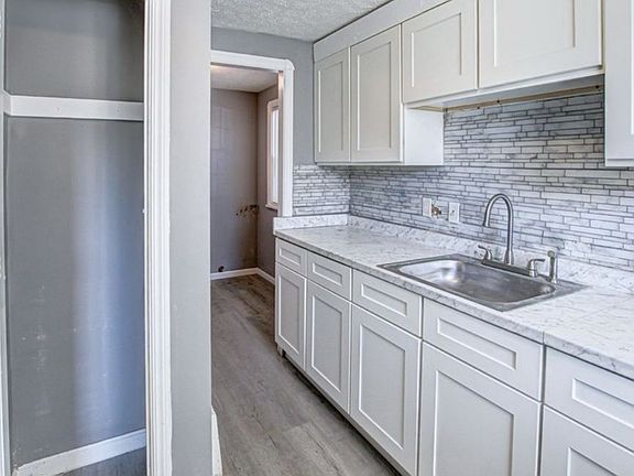 kitchen with new soft close cabinets, new counter top, backsplash and new flooring