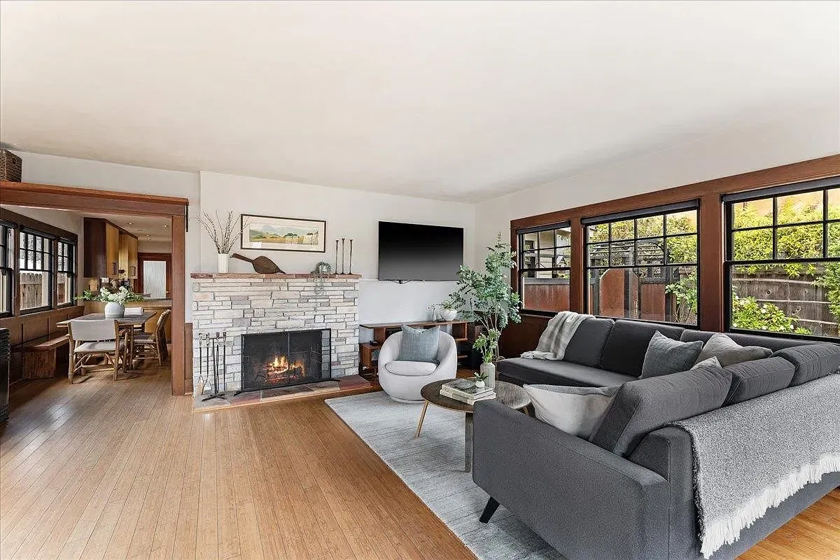 Spacious living room with amazing sunlight coming in from surrounding windows.