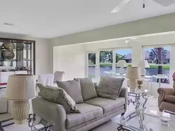 Great Room has lots of windows, mirror wall enhances soft light