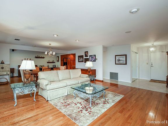 Spacious tiled foyer with mirrored double door coat closet.