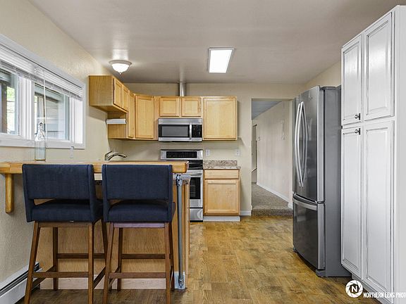 Pass-through kitchen with stainless french-door refrigerator