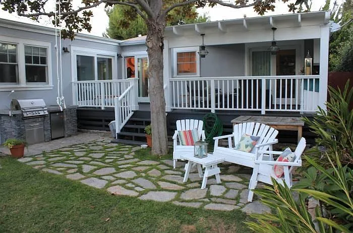 Backyard: Entertainment Area. Built-in BBQ with a refrigerator to keep cold drinks in. Up on the patio is more custom built-ins and up above them is a cupboard that has a tv in it. You can also sit under the magnolia tree over looking the jungle.