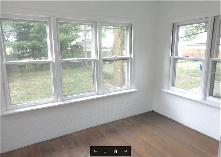ENCLOSED REAR PORCH OVERLOOKING BACK YARD