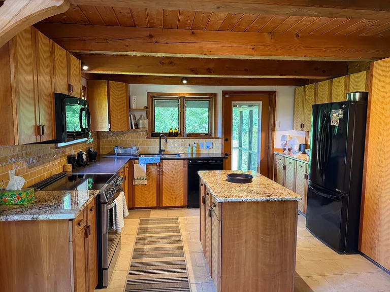 Granite counter tops and lovely wood cabinetry in the kitchen