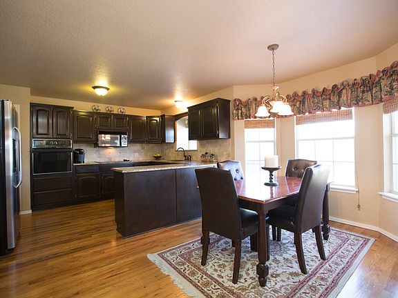 Rich hardwood floors continue into the generous Breakfast Nook featuring bay window overlooking back yard and oil rubbed bronze chandelier.