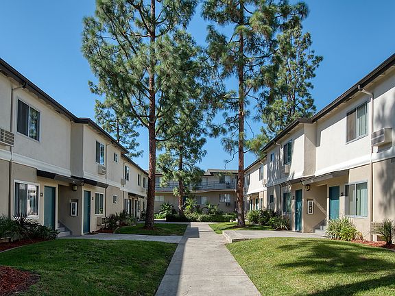Grassy courtyard with paths leading to apartment homes.