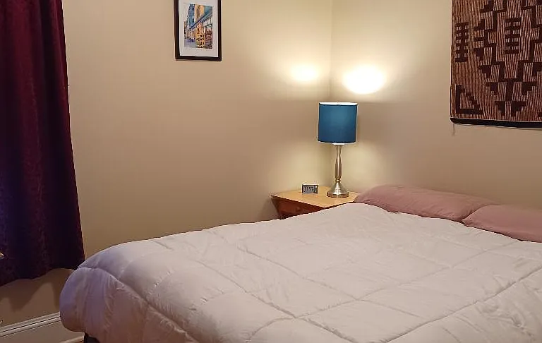 This cozy bedroom has a queen bed, large dresser and two bedside tables. Room darken shade and heavy drapes. All bedrooms have typical closets.