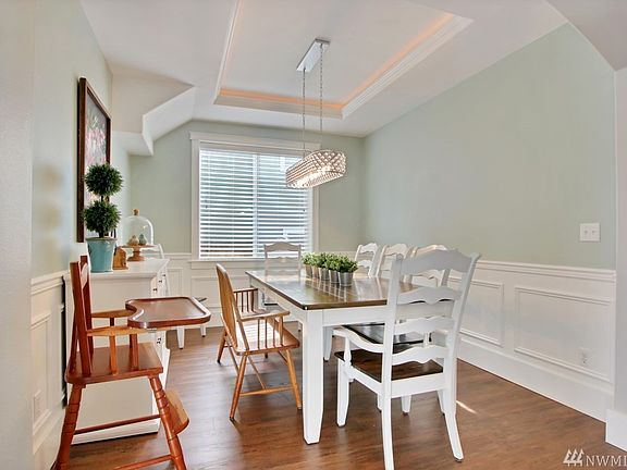 Large Dining room with coffered ceiling and wainscoting makes this a perfect space for family dinners.