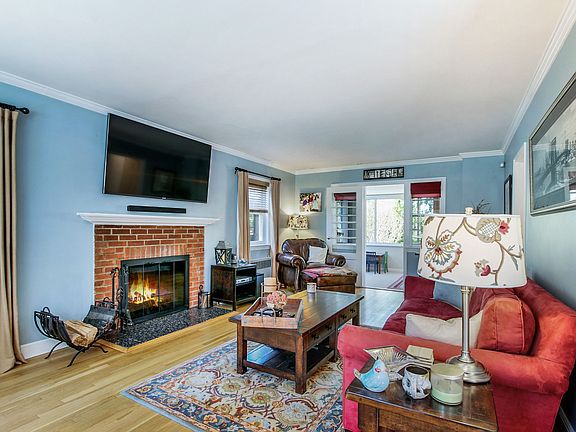 Large living space with fire place and entrance to playroom