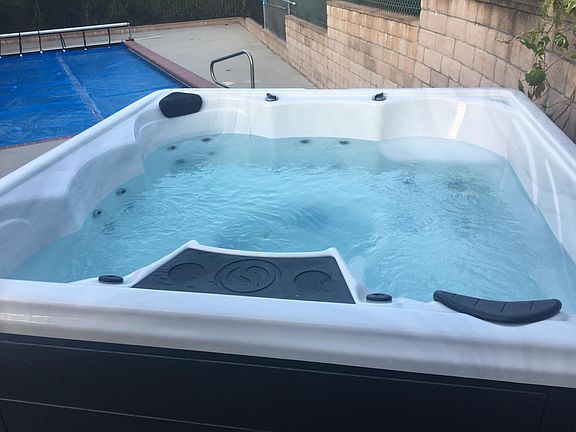 Hot tub next to unit available for use.