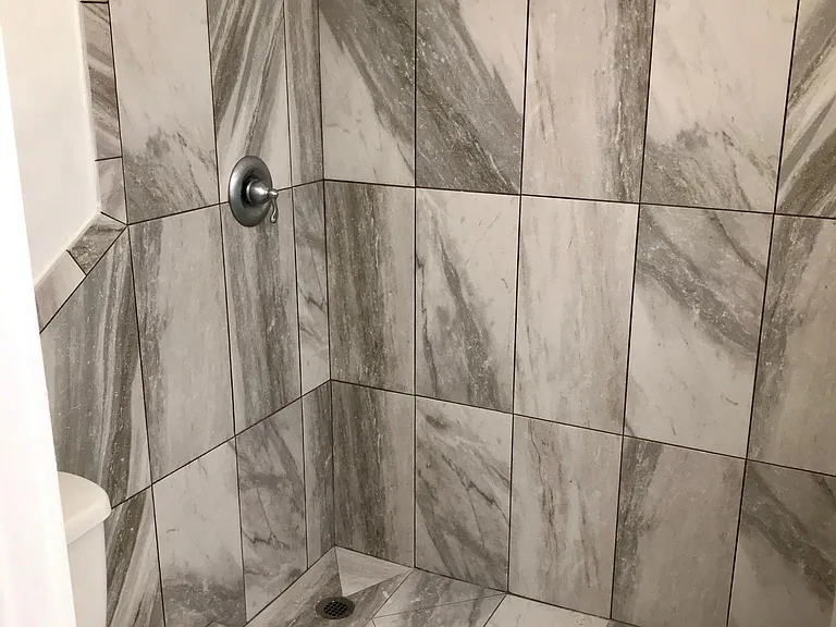 Bathroom 1. Tile shower and floors.
