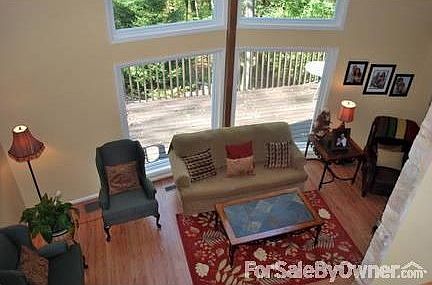 Living Room
						:
						enhanced with large windows and massive stone fireplace