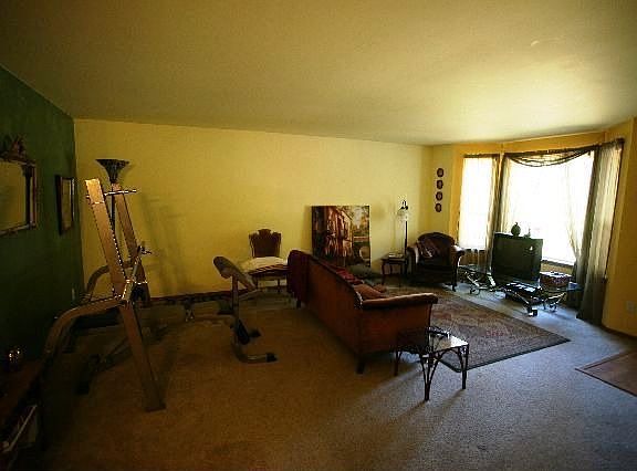 The living room has a large bay window. 