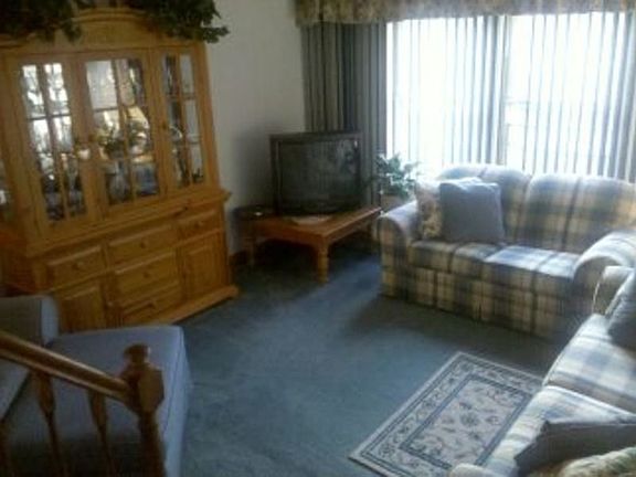 The Sunken Living Room is Fully Carpeted and has Large Windows allowing for plenty of Natural Light.