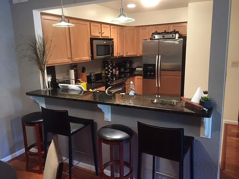 Kitchen Bar...See. I told you the Fridge was clean now (Not my taste in furniture design or counter clutter but whatever...)!