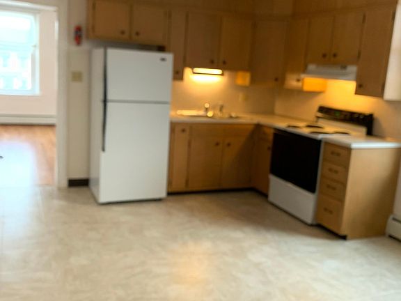 Kitchen with appliances, ceiling fan and large eating area