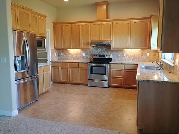 Large kitchen with S/S appliances, including fridge, microwave, electric range, & dishwasher