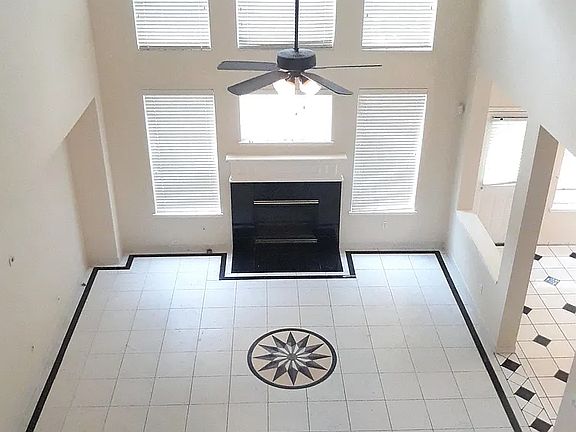 Living room with fireplace view from upstairs corridor