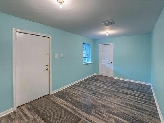 Entertainment room that can double as a spacious home office or kids playroom