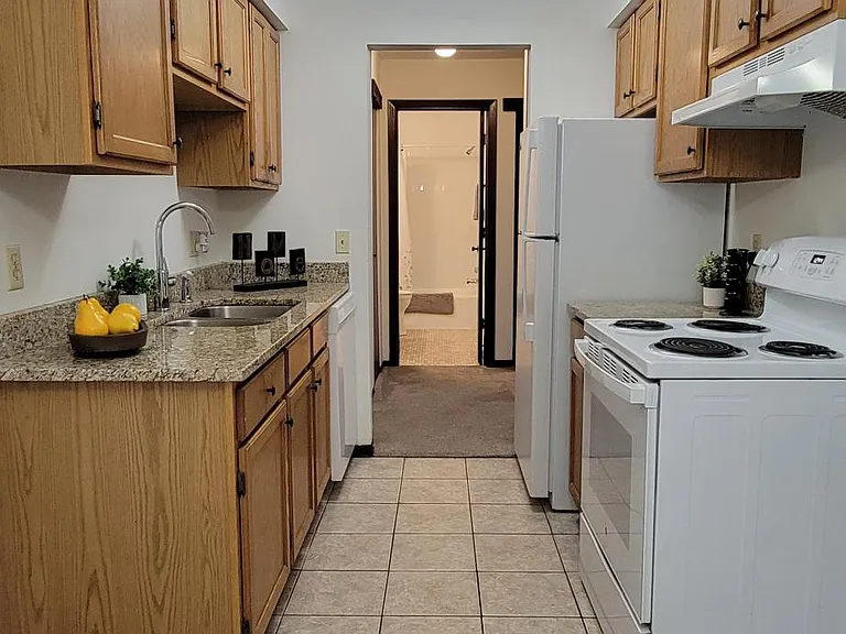 Kitchen layout with tan granite counter tops, Apt 107